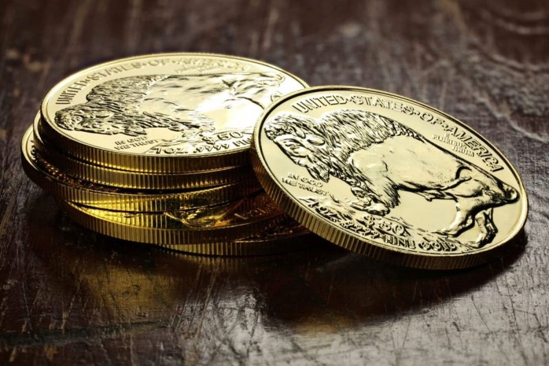 stack-of-shiny-gold-coins-featuring-a-buffalo-design-on-a-wooden-surface-CY6d6R-800×533-1